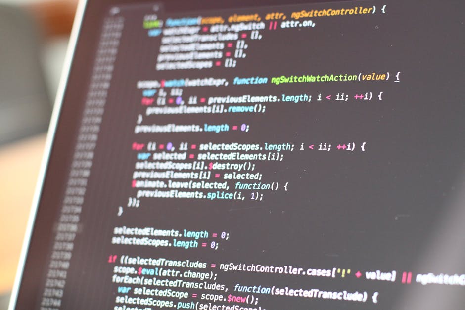 A close-up image of a computer screen displaying a code editor with lines of colorful programming code, including syntax highlighting in shades of pink, blue, green, and white. The screen is slightly